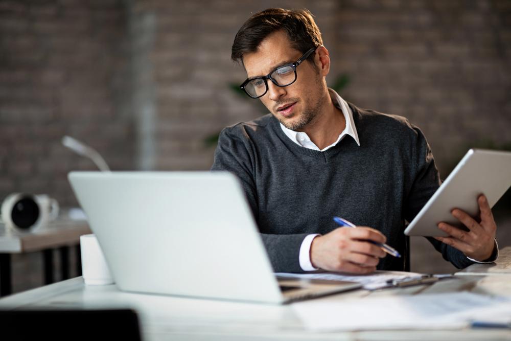 A man reviews data on a laptop. As part of the e-discovery process users will be able to review data upload to the e-discovery platform. 