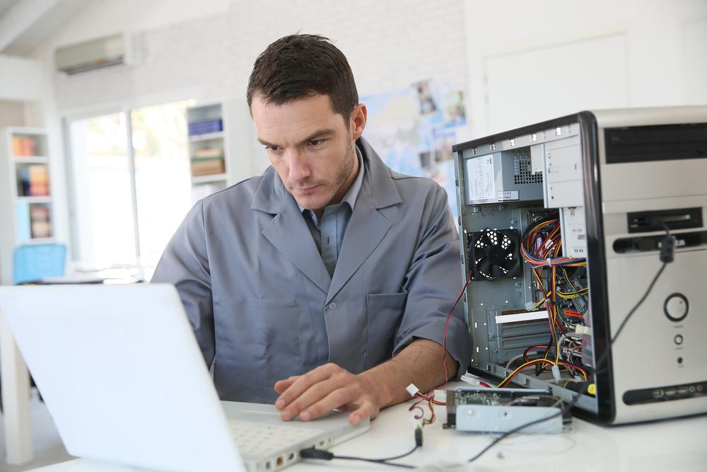 A digital forensic examiner collects data from a desktop computer. The data recovery effort often starts with the collection of data so that file recovery can be performed on a duplicate copy of the original evidence media. 